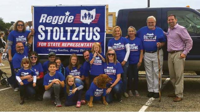 Group of people from Reggie's campaign in front of a truck with a banner promoting him for state representative