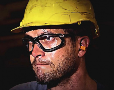 A man wearing protective eyewear and a hard hat