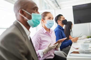 Group of people in a conference room wearing face masks