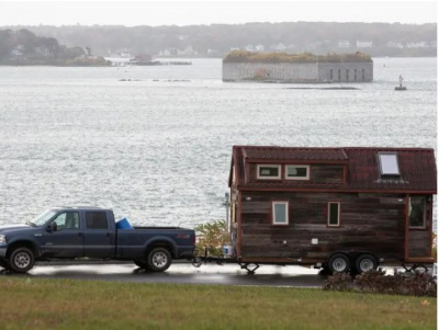 A truck pulling a tiny home