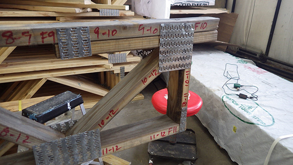 A truss plate on a truss prior to repressing