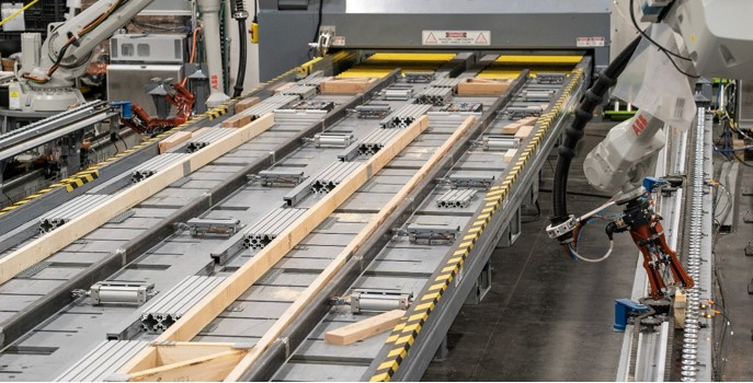 Assembly of floor trusses – ABB robots place spliced and preplated chords with connector plates on the bottom. Webs are placed with connector plates on the top to avoid flipping. 